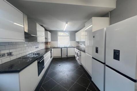 Modern galley kitchen with glossy white cabinet...