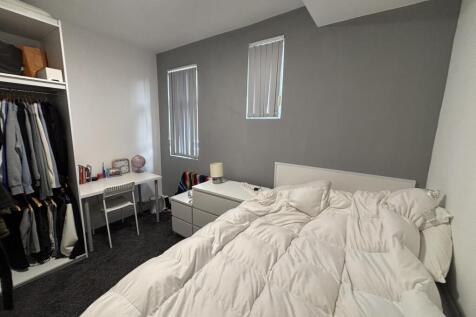 A bright and spacious master bedroom featuring ...