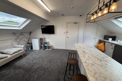 A spacious and modern living room with ample na...