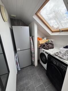 A compact kitchen area with a large skylight pr...