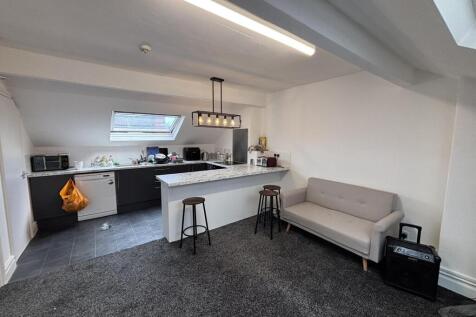 A bright and modern living room featuring a com...