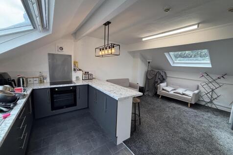 A modern, well-lit kitchen area with spacious c...