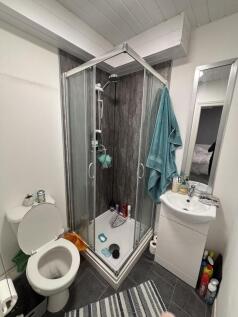 A modern bathroom featuring a shower enclosure,...