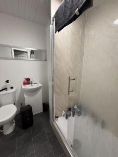 A clean and functional bathroom with a shower e...