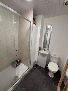 A clean and functional bathroom with a shower e...