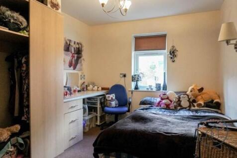 A cozy and well-maintained bedroom featuring a ...