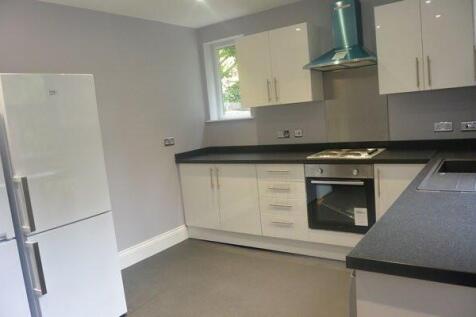 A modern, bright kitchen with fresh white cabin...
