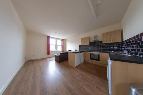 A spacious and well-lit living room with large ...