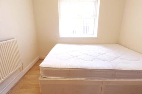 A bright and tidy bedroom with a comfortable be...