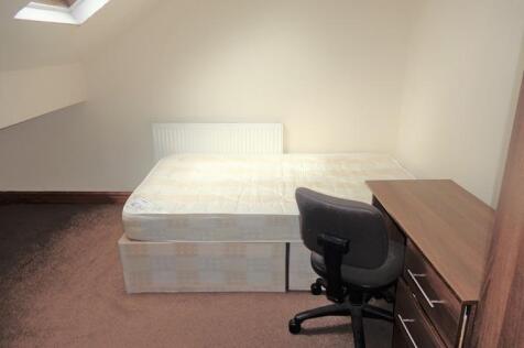 A bright and tidy living room featuring ample n...