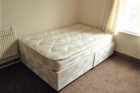 A comfortable double bedroom featuring a large ...