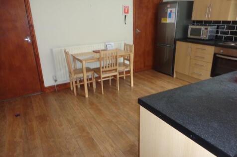 A functional kitchen area featuring wooden cabi...