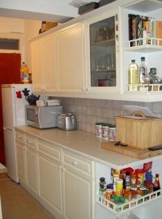 Clean and well-organized kitchen with ample cou...
