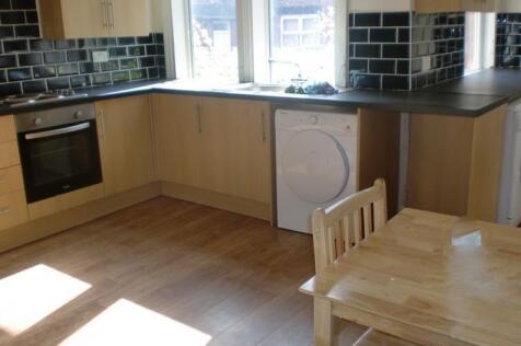 A bright and tidy kitchen area featuring modern...