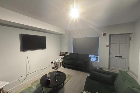 A modern, well-lit living room with comfortable...