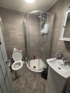 A well-maintained bathroom featuring a shower e...