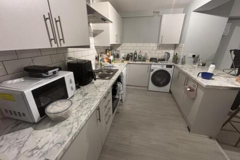 A well-maintained modern kitchen with ample wor...