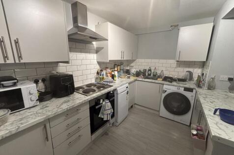 A modern, well-lit kitchen featuring ample coun...