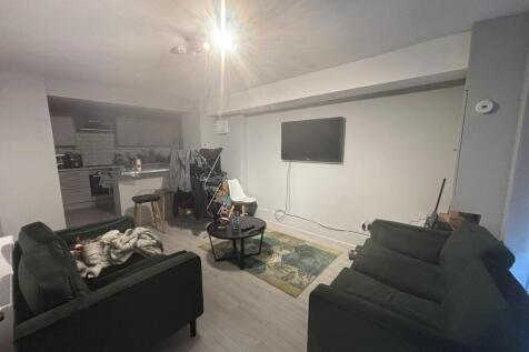 A cozy living room featuring comfortable sofas,...