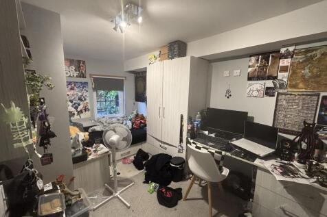 A cozy living room filled with personal items, ...