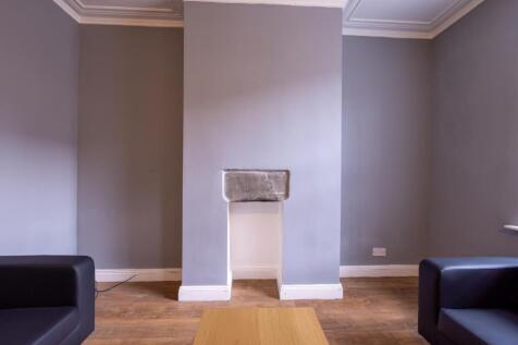 Bright, modern living room with neutral grey wa...