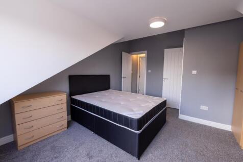Bright, modern furnished bedroom with a double ...
