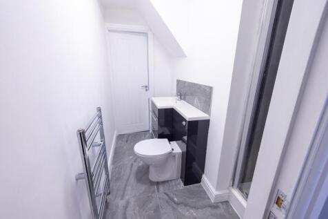Bright, modern bathroom with tiled floor, heate...