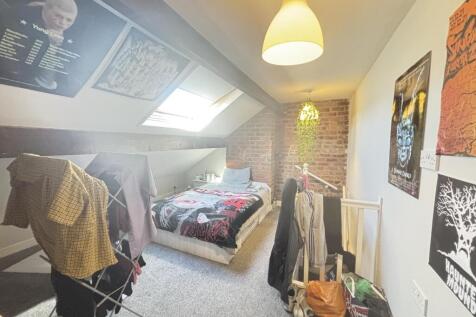 A bright and cozy bedroom with natural light fr...