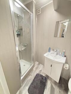 A clean and modern bathroom featuring a shower ...