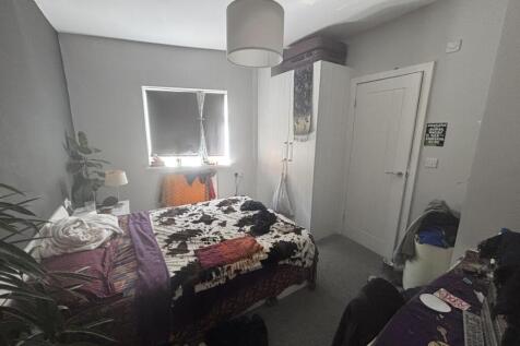 A cozy bedroom featuring a double bed with colo...