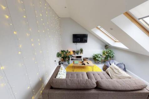 Bright and spacious living room featuring an el...