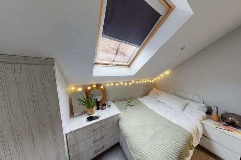 A bright and spacious master bedroom featuring ...