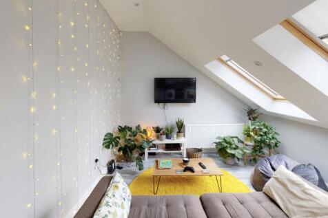 Bright and welcoming living room with ample nat...