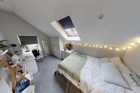 Bright and cozy bedroom with ample natural ligh...