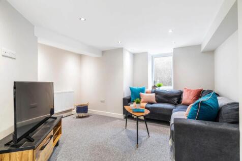 A bright and modern living room featuring comfo...