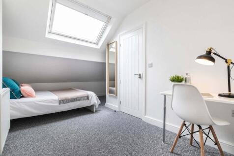 A neatly presented single bedroom with a cozy a...