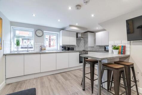 Bright and modern kitchen with ample natural li...