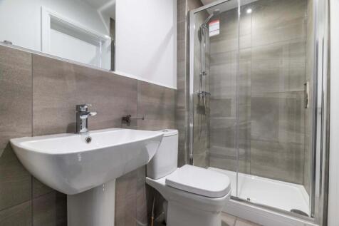 A modern, clean bathroom featuring a spacious s...