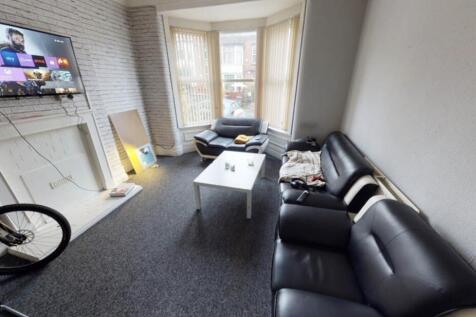 A modern, well-lit living room with a comfortab...