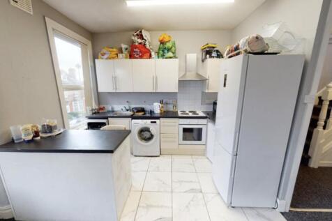 A bright and clean kitchen with white cabinets ...