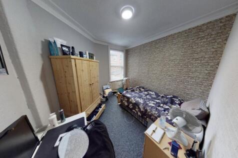 A well-maintained bedroom featuring a double be...