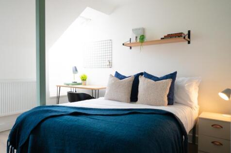 A bright and inviting double bedroom featuring ...