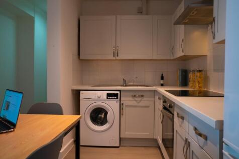 A modern kitchenette featuring clean lines and ...