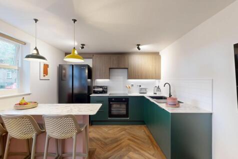 Bright modern kitchen with a breakfast bar, thr...