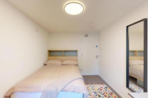 Bright, tidy bedroom with a double bed, neutral...