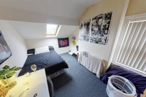 A well-maintained bedroom featuring a comfortab...