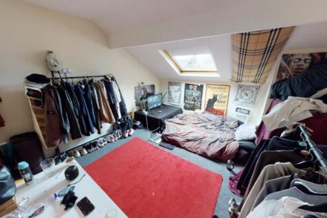 A cozy bedroom with a large window providing na...