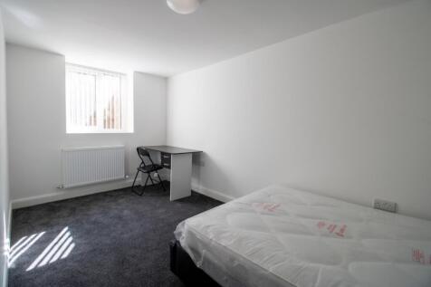 A bright and clean bedroom featuring a double b...