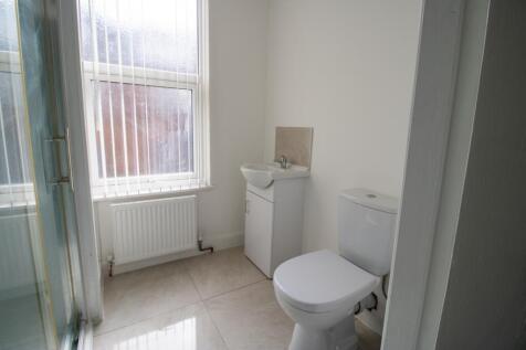 A bright and clean bathroom with a modern toile...