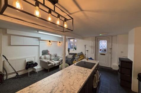 A modern and well-lit living room featuring com...